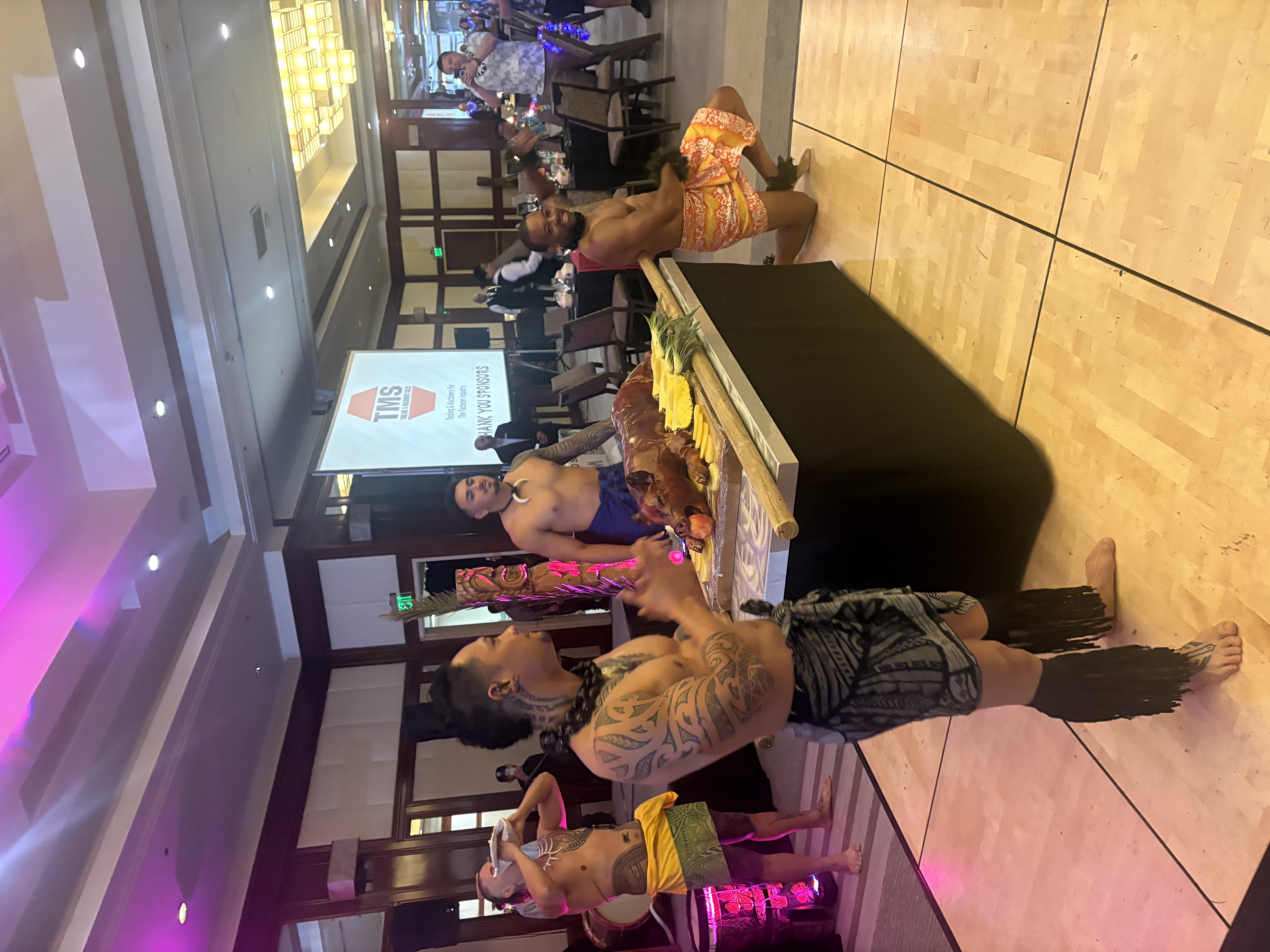 Polynesian dancers performing at a luau event